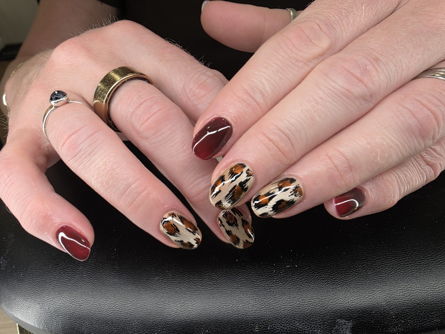 Glossy burgundy and leopard print nail art